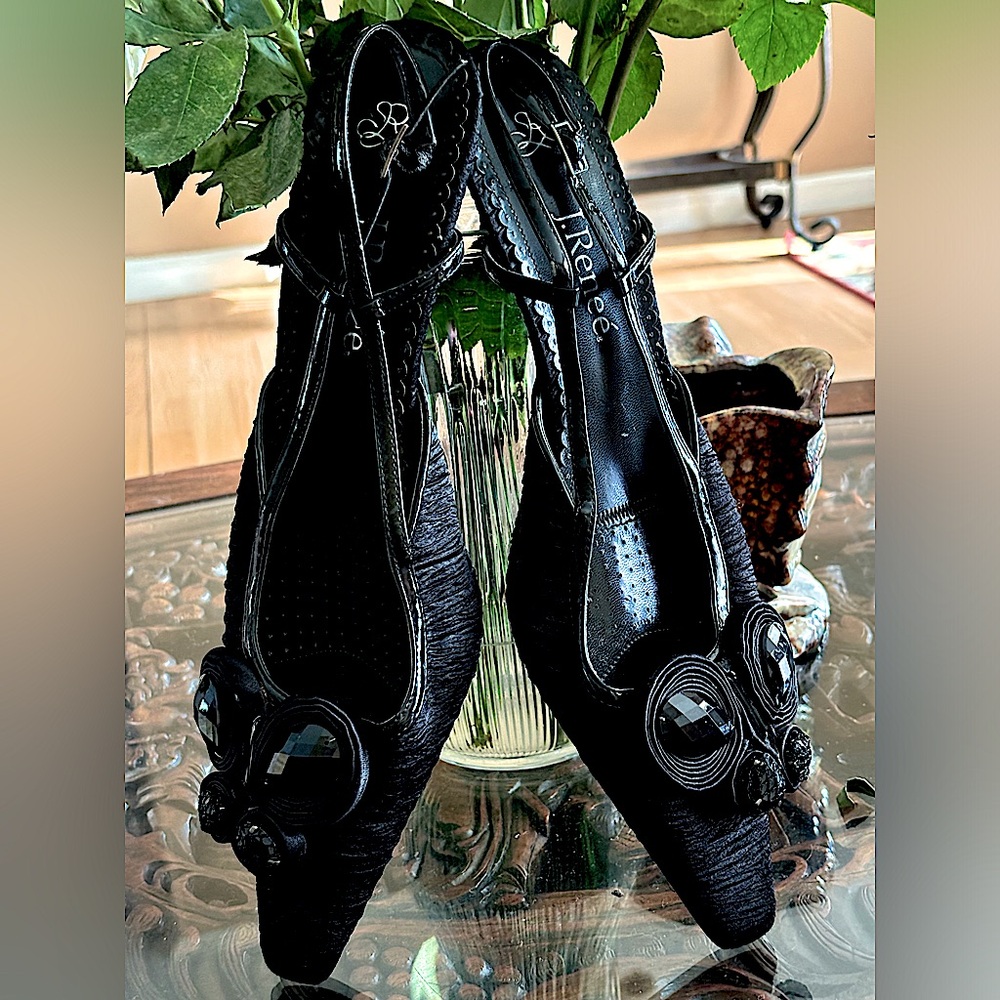 Black ruched fabric, sling-back, three-inch heels w/ side pendant.